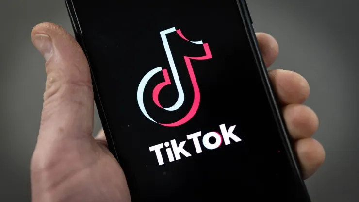 LONDON, ENGLAND – FEBRUARY 28: In this photo illustration, a TikTok logo is displayed on an iPhone on February 28, 2023 in London, England. This week, the US government and European Union's parliament have announced bans on installing the popular social media app on staff devices. (Photo by Dan Kitwood/Getty Images)
